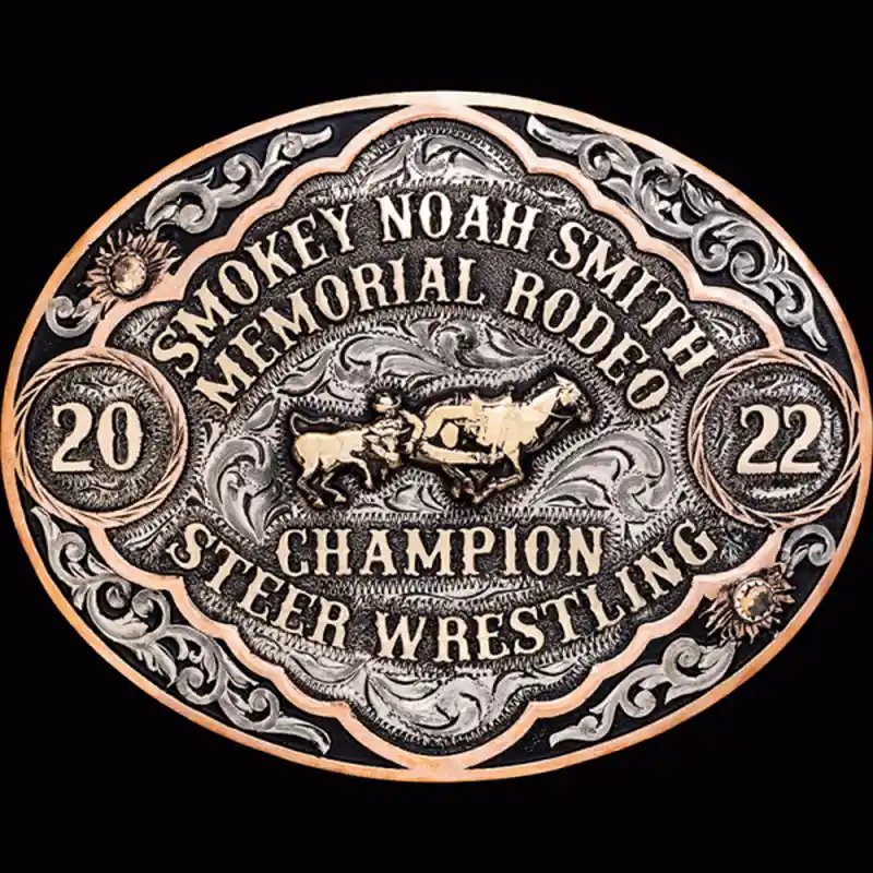 A custom oval rodeo belt buckle award for Smokey Noah Smith Memorial Rodeo Champion featuring a steer wrestling figure 