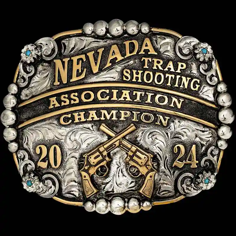 A custom trophy men's belt buckle for Nevada Trap Shooting Association Champion featuring crossed pistols figure 