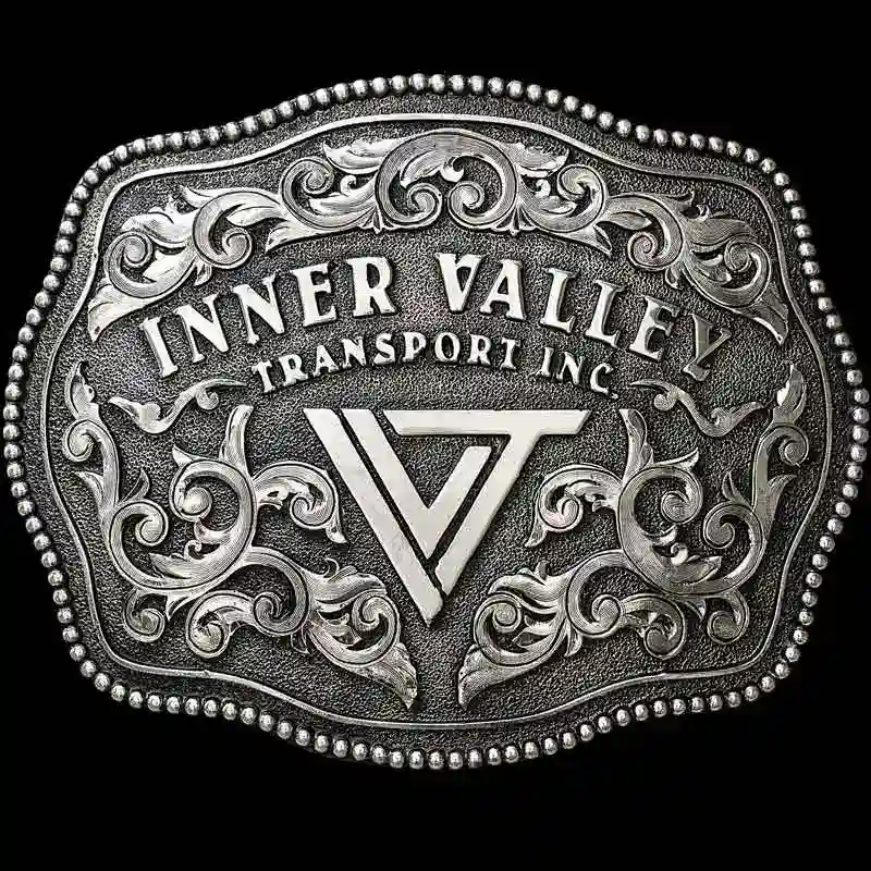 A custom antiqued silver belt ranch bel tbuckle for Inner Vallery Transport Inc. featuring a ranch custom logo