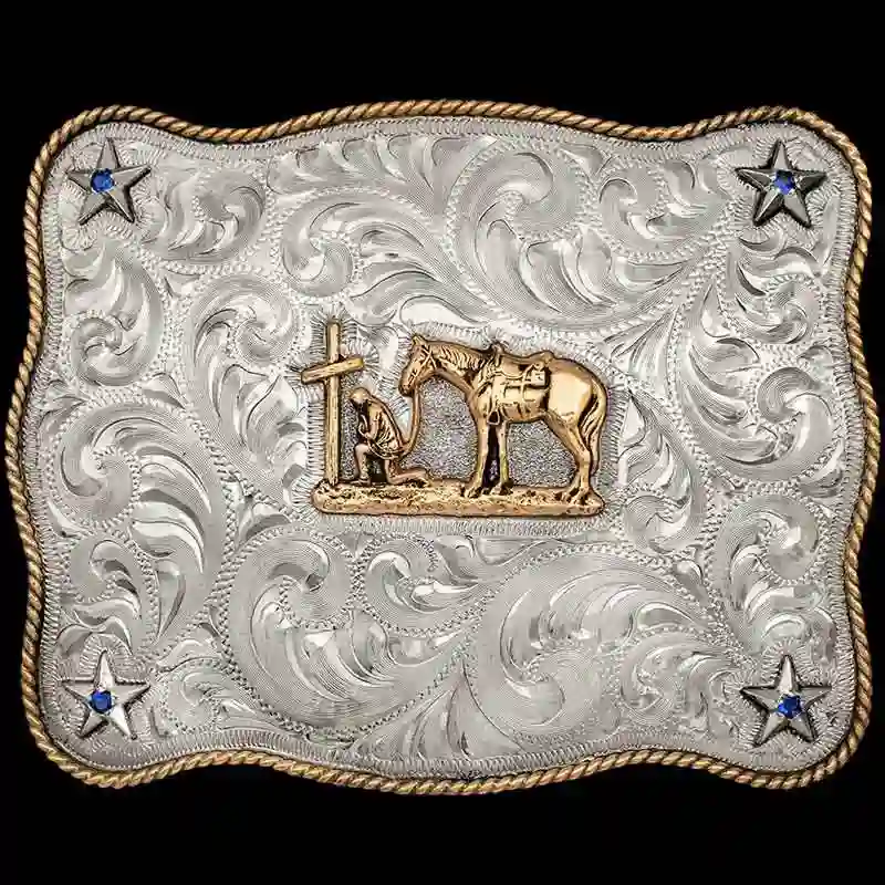 A custom western belt buckle featuring a praying cowgirl figure 