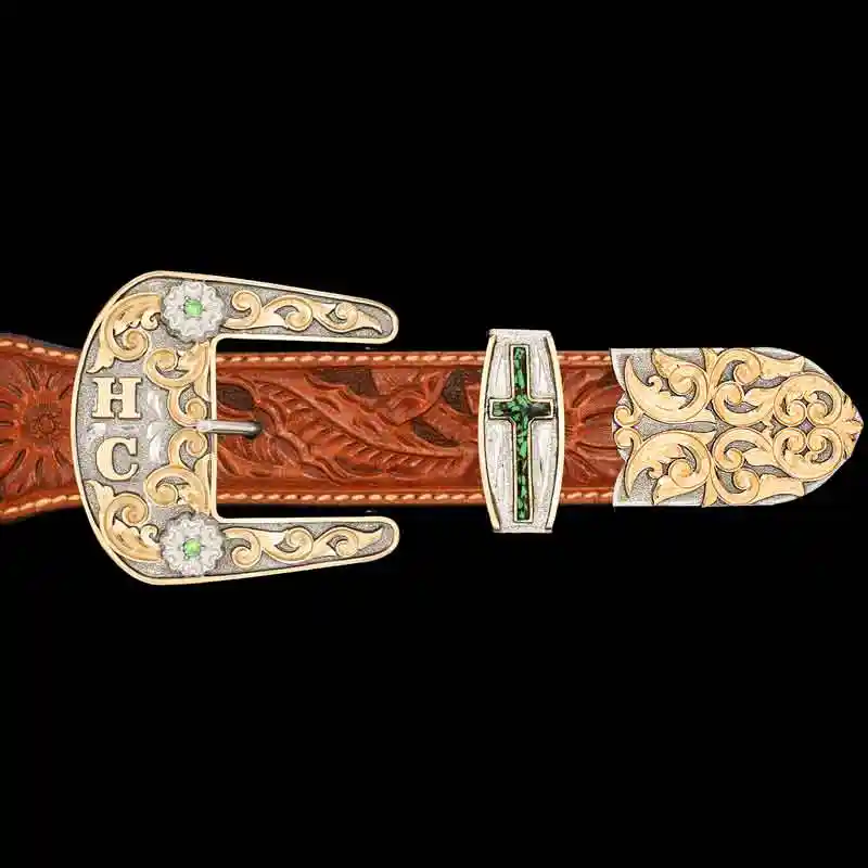 A custom western three piece belt buckle set featuring bronze scrollwork 