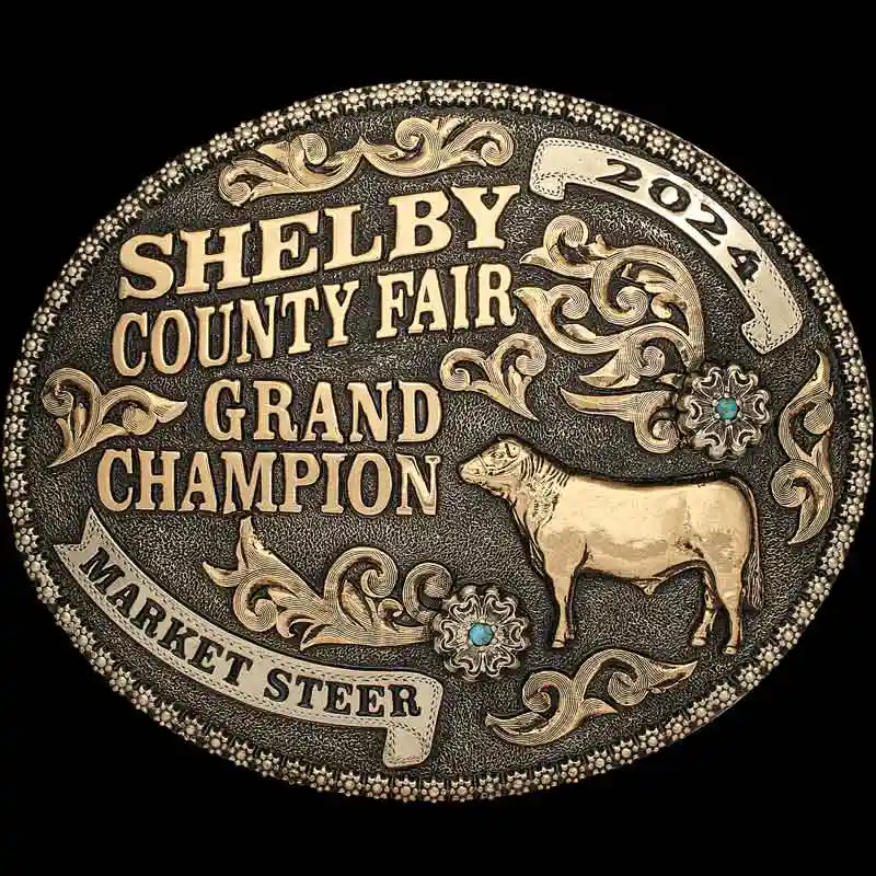 A custom golden award belt buckle for Shelby County Fair Grand Champion Market Steer featuring a cow figure 