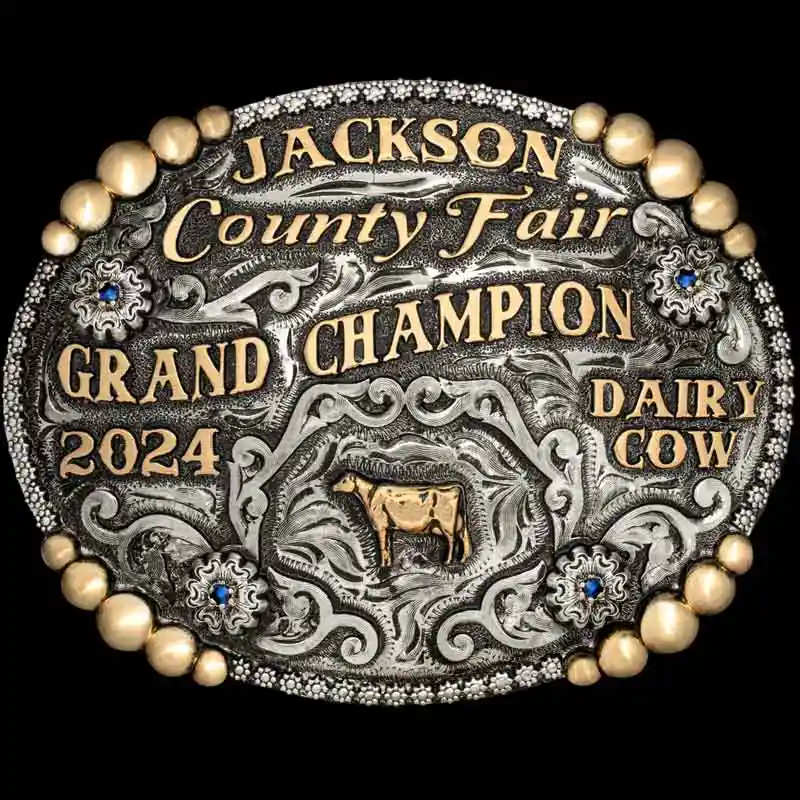 A custom oval farming belt buckle trophy for Jackson County Fair Champion featuring a cow figure