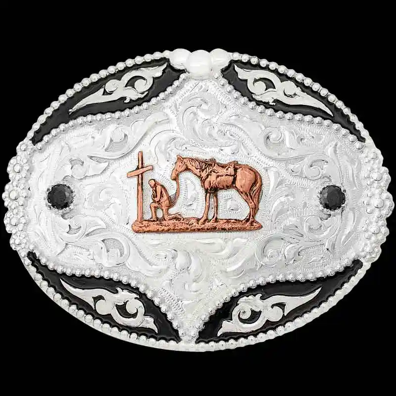 A custom western belt buckle for men featuring a praying cowboy to a cross figure 