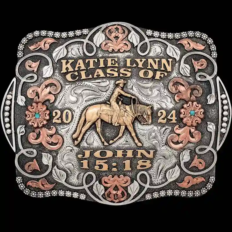 A custom women's graduation belt buckle featuring a cowgirl figure and bible verse 