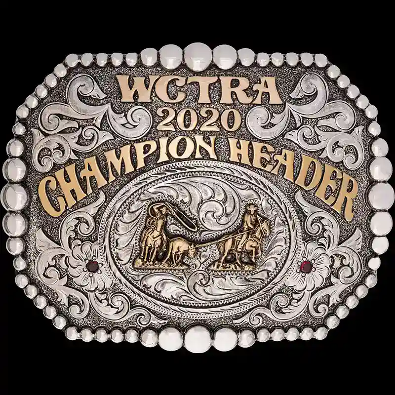 A custom rodeo belt buckle trophy for WCTRA Champion Header featuring a team roping figure 