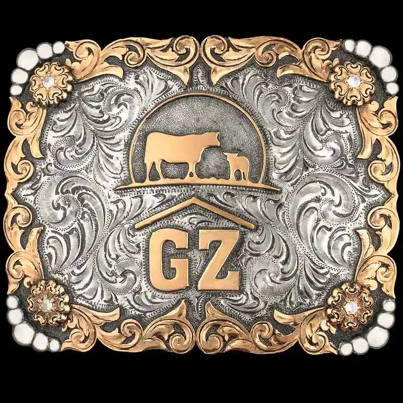 A custom ranch brand belt buckle featuring a cow and calf figure 
